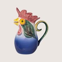 Vintage hand-painted ceramic rooster pitcher from Portugal with vibrant blue, red, and green glaze.