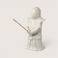 Vintage white ceramic Benihana Kendo warrior figurine with embossed branding on the back.