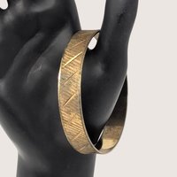 Vintage Park Lane gold tone textured metal bangle bracelet with geometric etching.