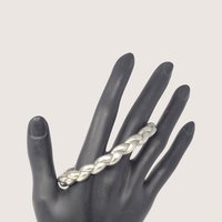 Vintage pewter braided bangle bracelet with a dimensional woven metal design.