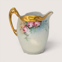 Antique RC Bavaria porcelain creamer decorated with pink roses and heavy gold gilt handle and rim.