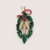 Vintage gold tone and enamel Christmas brooch featuring green holly leaves, red berries, and a red ribbon bow.