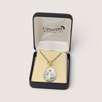 Vintage Crescent Memorial teardrop intaglio pendant with a cross bail, displayed in its original box with a chain.
