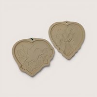 Pair of vintage 1989 and 1992 Hill Design Brown Bag stoneware heart cookie molds featuring hummingbird and tulip designs.