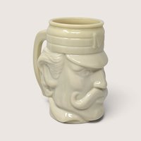 Vintage 1970s Avon cream glazed ceramic novelty character mug of a vintage baseball player with cap and mustache.