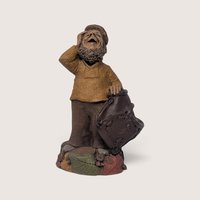 Vintage signed Tom Clark "Who" figurine depicting a bearded woodland gnome shielding his eyes atop a base of autumn leaves.