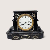 19th-century Japy Freres black lacquer mantel clock with intricate mother of pearl inlay and a white enamel dial.
