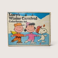 1972 vintage Lucy's Winter Carnival Colorforms box featuring Peanuts characters Charlie Brown, Lucy, and Snoopy ice skating.