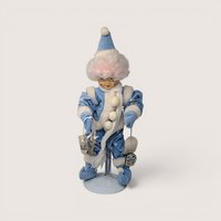Vintage 1986 Brinns January calendar clown doll in blue winter outfit holding miniature ice skates