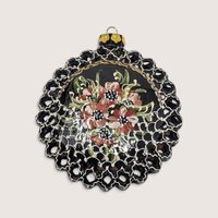 Vintage round handpainted black clay Christmas ornament with floral design and pierced lace border