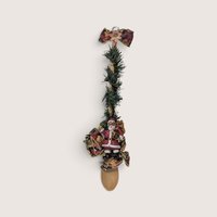 Vintage handmade wooden spoon decorated with faux pine garland and a Santa figure for Christmas wall hanging