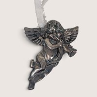Vintage pewter cherub or angel ornament marked R and B on the back with a white ribbon hanger