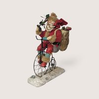 Vintage Smithsonian Institution Santa on bicycle Christmas figurine.