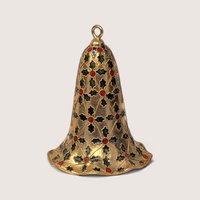 Close-up detail of vintage enamel and metal bell ornament showing green and red holly design.