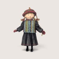Vintage 1998 Lang and Wise girl resin Christmas tree ornament wearing a patterned jacket and red hat.