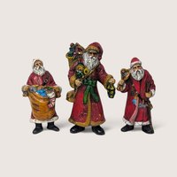 Set of 3 vintage plastic Santa Claus figures and ornaments in traditional red coats.