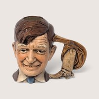 Vintage hand-painted ceramic character mug depicting Will Rogers with a cowboy boot handle and his famous quote.