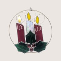 Vintage iridescent stained glass Christmas candles suncatcher featuring green holly leaves, red wax drips, and glass jewel berries.