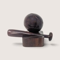 Vintage hand-carved wooden baseball and bat display figurine on a dark wood block base.
