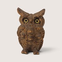 Vintage exotic wood carved owl figurine with natural grain patterns and inset yellow glass eyes.