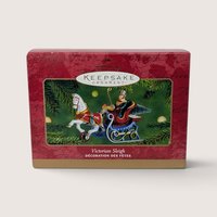 Vintage Hallmark Keepsake Victorian Sleigh die-cast metal Christmas ornament featuring a driver and a white horse pulling a blue and red sleigh.   