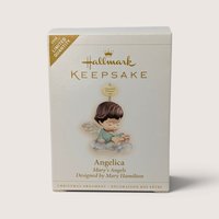 A boxed 2006 Hallmark Keepsake Marys Angels Angelica limited quantity ornament featuring an angel on a cloud.