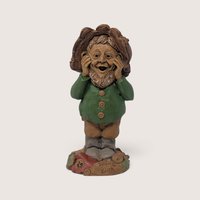 A vintage Tom Clark signed "What" resin gnome figurine from Cairn Studio, standing in a green jacket with a surprised expression.