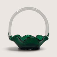 A vintage green art glass basket with a ruffled crimped rim and an applied clear glass handle.