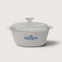A vintage Corningware 2.5 quart square casserole dish in the blue cornflower pattern with a matching glass lid on a neutral background.