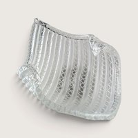 A vintage clear and white latticino optic ribbed art glass folded bowl with a handkerchief rim on a neutral background.
