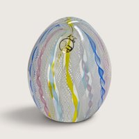 A vintage Vecchia Murano hand-blown glass paperweight egg featuring vertical white latticino lace and colorful twist ribbons with a VR sticker on a neutral background.   