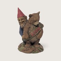 A vintage 1998 Tom Clark resin gnome figurine titled Grin and Bear It hugging a bear with a banner against a neutral background.