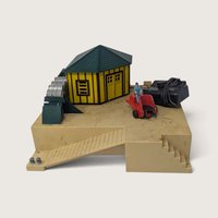Vintage 1950s American Flyer No 779 oil drum loader platform with yellow depot and red forklift truck on a white background.   
