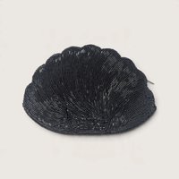 Vintage black glass bugle beaded clamshell-shaped evening clutch purse with zipper on a neutral background.   