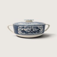 Vintage Royal China Currier and Ives blue transferware round covered casserole dish with carriage motif on a white background.   