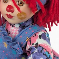 Vintage Porcelain Clown Doll, 9" Sitting Jester with Red Yarn Hair, Collectible Shelf Sitter Doll in Floral Star Dress