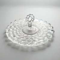 A 11.5-inch round clear glass serving tray featuring the Fostoria American 3D cube pattern and an ornate center glass handle.