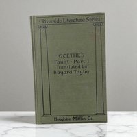 An antique olive green hardcover book titled Goethe's Faust. The binding features a smooth matte texture with dark embossed lettering and a simple vertical line design. The silhouette is rectangular with sharp, well-preserved corners.