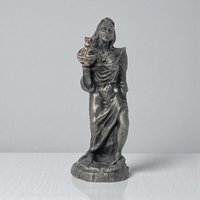 A solid pewter figurine of a slender female form standing atop a small integrated base. The metal has a soft, satin-like luster and a smooth, flowing silhouette that emphasizes graceful lines.
