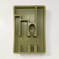 An avocado green molded plastic cutlery tray with a curved, rectangular frame. The interior features several divided sections of varying shapes and lengths designed to organize utensils, including a unique U-shaped compartment in the center.