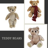 A trio of plush teddy bears in varying shades of tan and honey. Each bear features a fuzzy, short-pile texture and a classic seated or standing silhouette with jointed limbs. One bear wears a deep red knit scarf with tasseled ends and a geometric pattern.