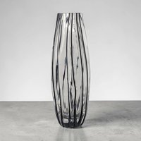 Tall, slender glass vase with a narrow 2-inch opening. The body features alternating vertical stripes of opaque white and clear glass. The silhouette tapers toward a flared rim and sits on a sturdy, clear glass base.