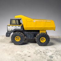 A large vintage Tonka 768 Mighty dump truck in classic yellow and black. The toy features a heavy-duty metal yellow bed and a black plastic cab and chassis with oversized treaded tires. The silhouette shows authentic age with minor rust and wear consistent with play.