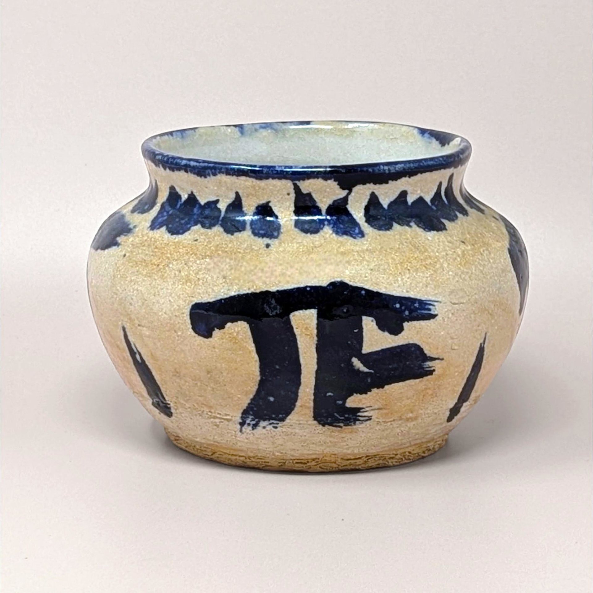 Handcrafted 1970s Senty studio pottery bowl featuring raw sand stoneware and bold cobalt blue abstract markings.