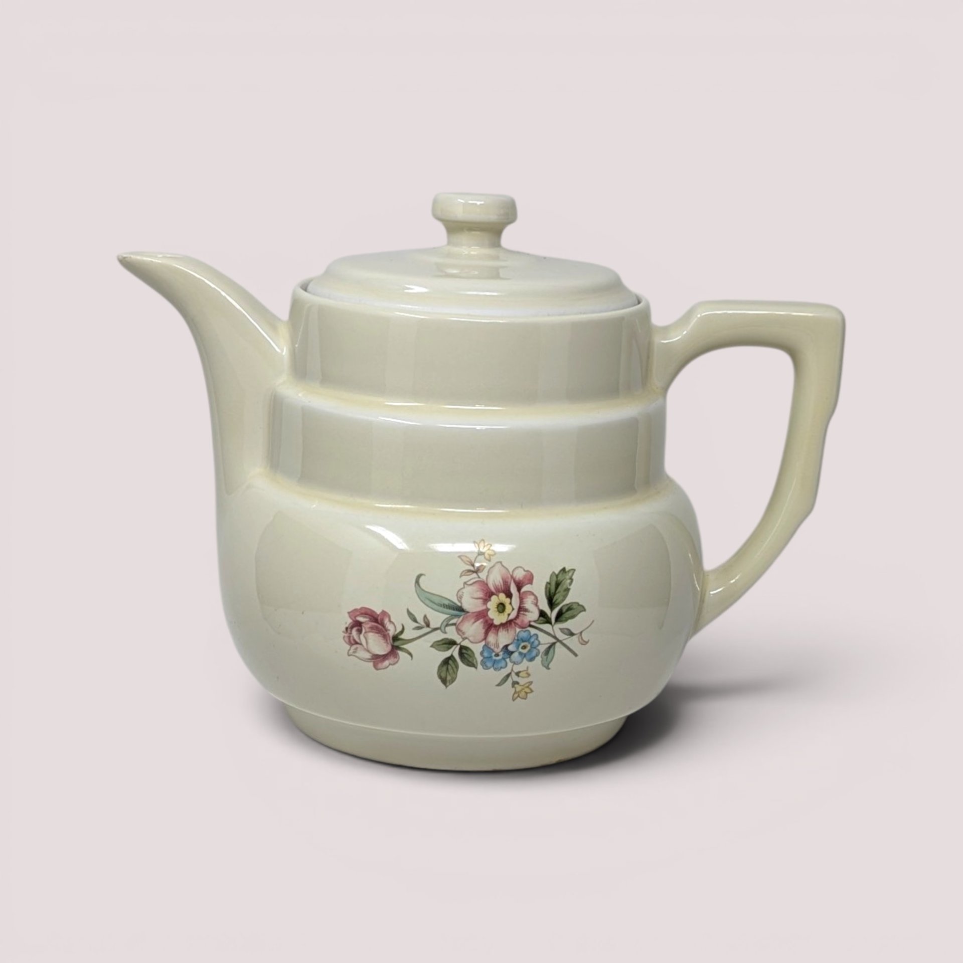 Vintage cream ceramic Hall Rambling Rose coffee pot with lid featuring a colorful floral pattern.