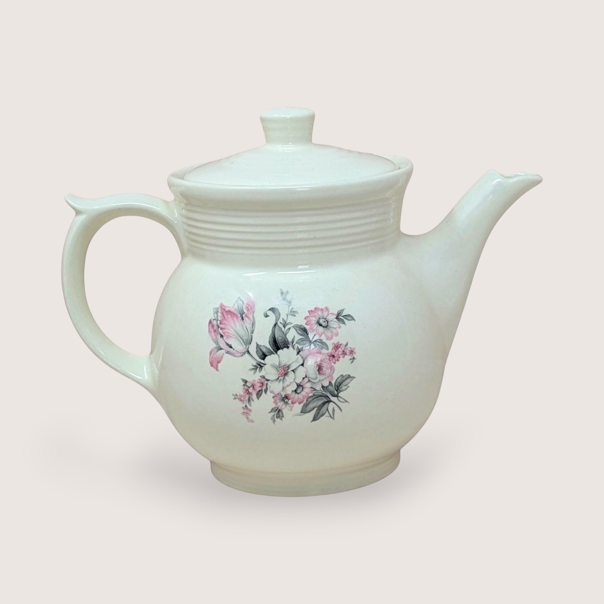 Vintage cream ceramic Drip-O-Lator coffee pot and lid. Features a central floral spray of pink tulips and white daisies. Sculptural scroll-top handle and tiered "stepping" on the neck. 7.25 inches tall.