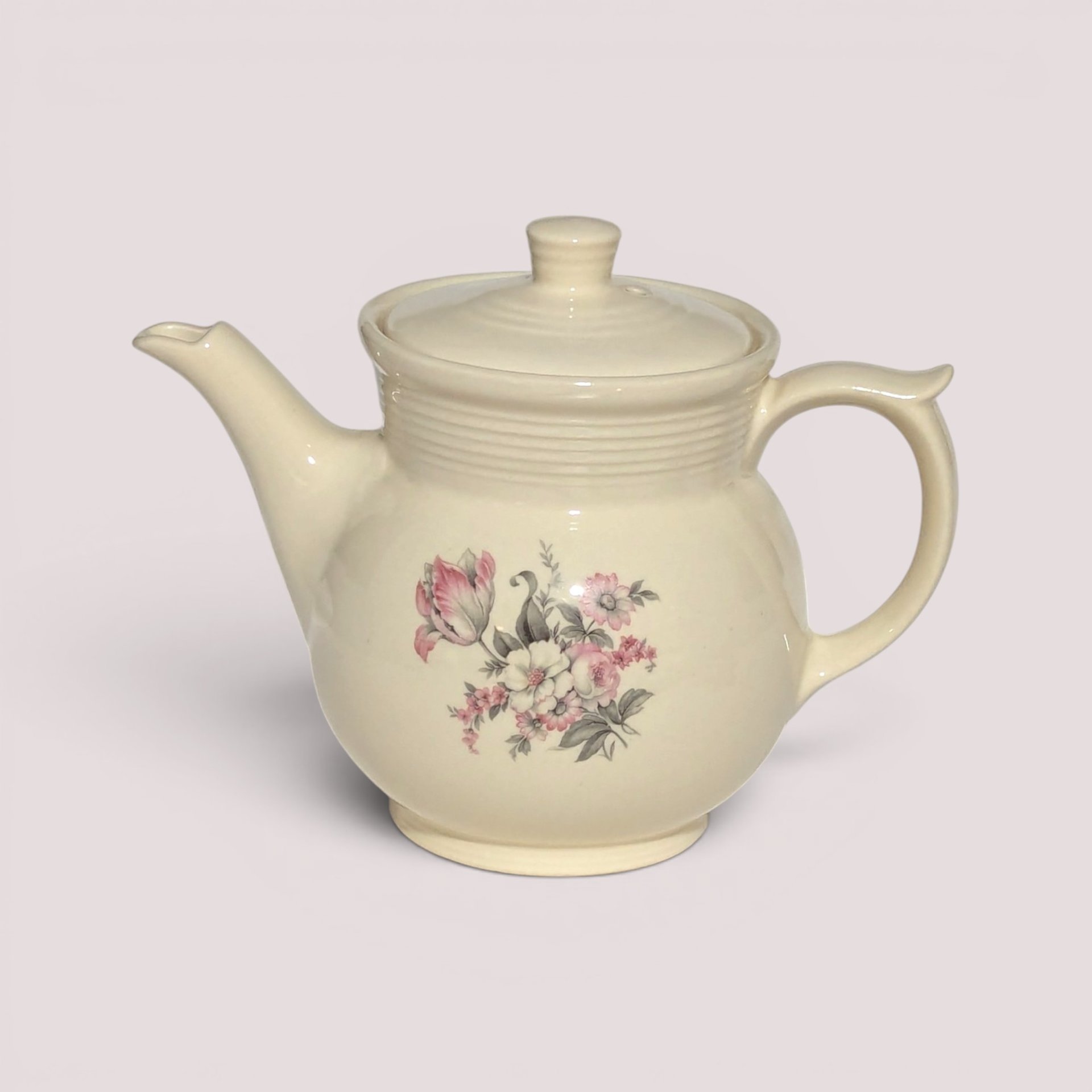 Vintage cream ceramic Drip-O-Lator coffee pot with lid featuring a pink floral decal design.