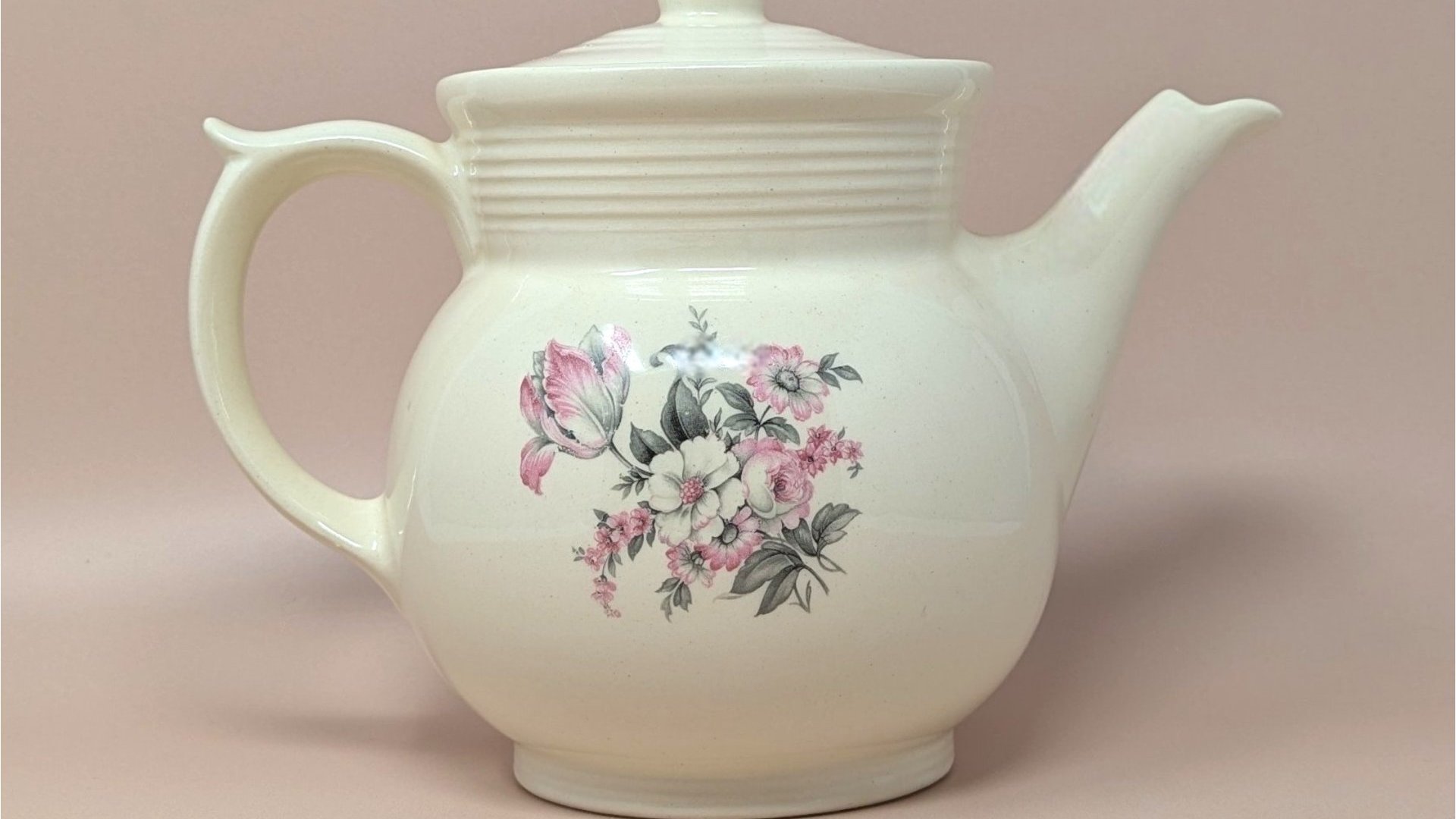 Vintage cream ceramic Drip-O-Lator coffee pot and lid. Features a central floral spray of pink tulips and white daisies. Sculptural scroll-top handle and tiered "stepping" on the neck. 7.25 inches tall.