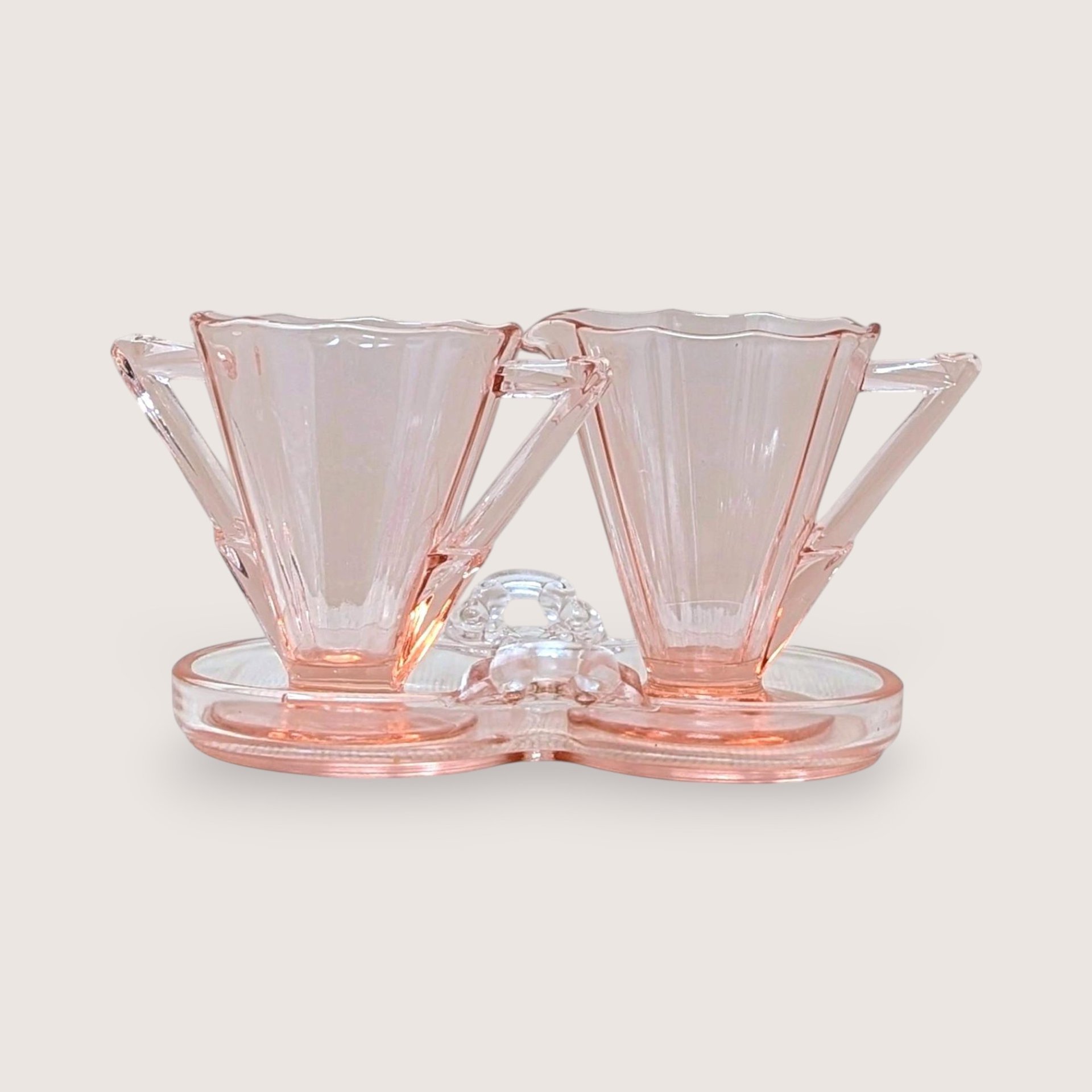 Vintage Cambridge pink glass sugar and creamer set on a matching double-well tray. Features 10-sided decagon panels and sharp geometric handles. 3.5 inches tall.