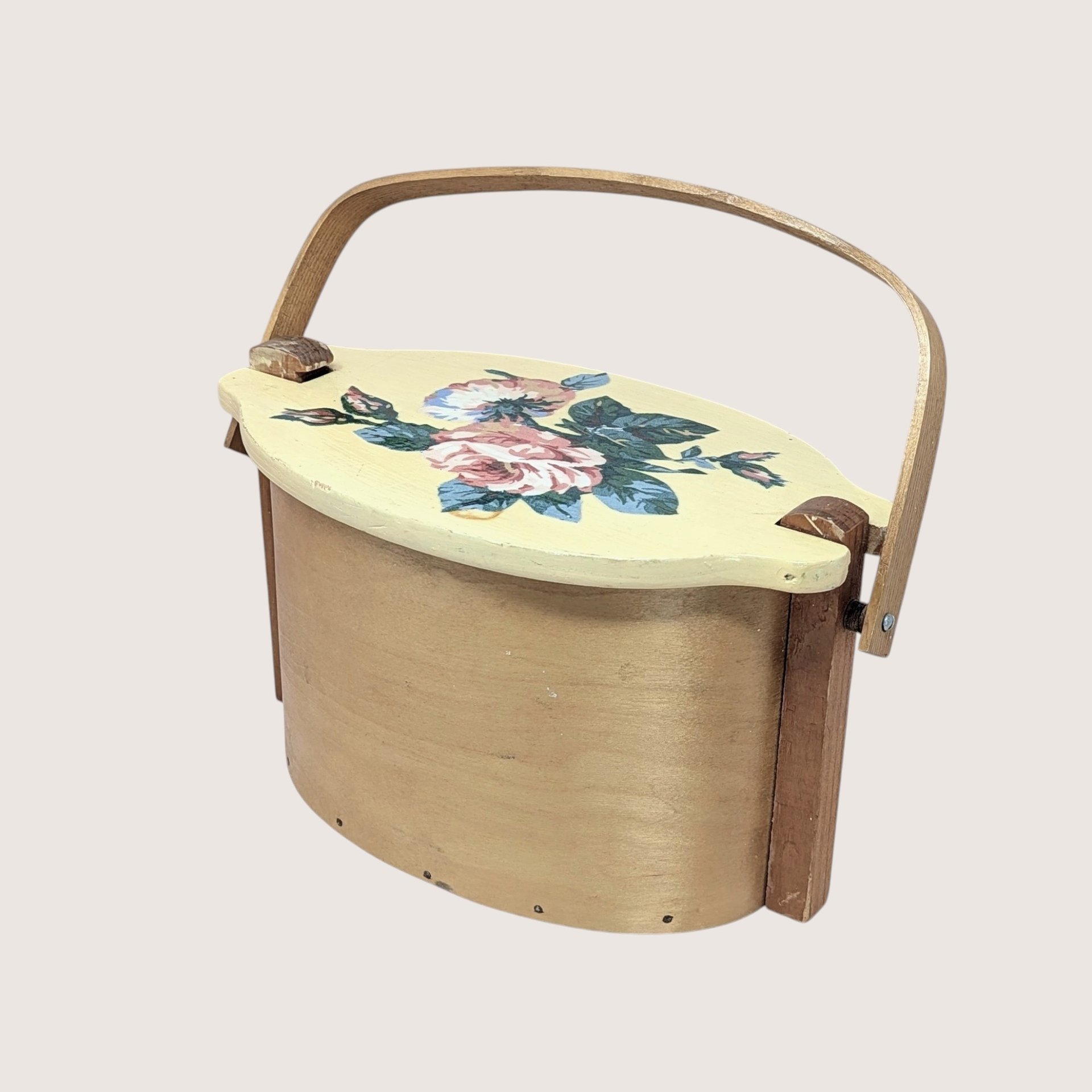 Vintage Basketville wood bucket with a swing handle and fitted lid. Features a hand-painted pink rose and blue floral bouquet on a cream-colored lid. Natural light wood finish. 11.5 inches long.